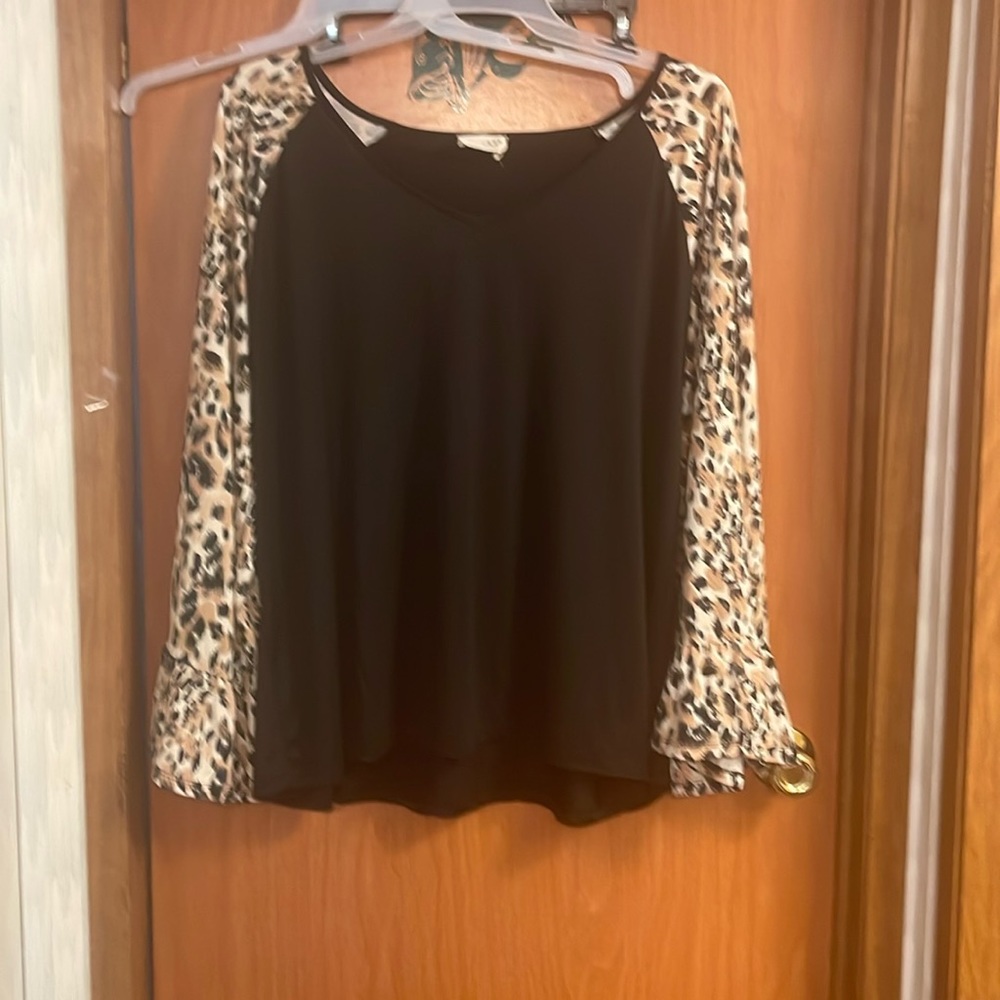 Black with Lepard print bell sleeves.  Light flowy top.